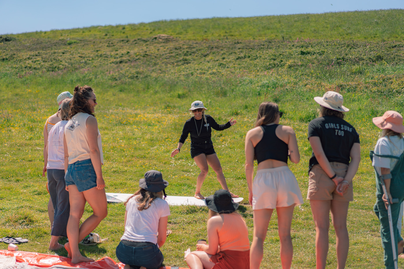 A group at Gather and Glide. Learning surf technique in the sun. 