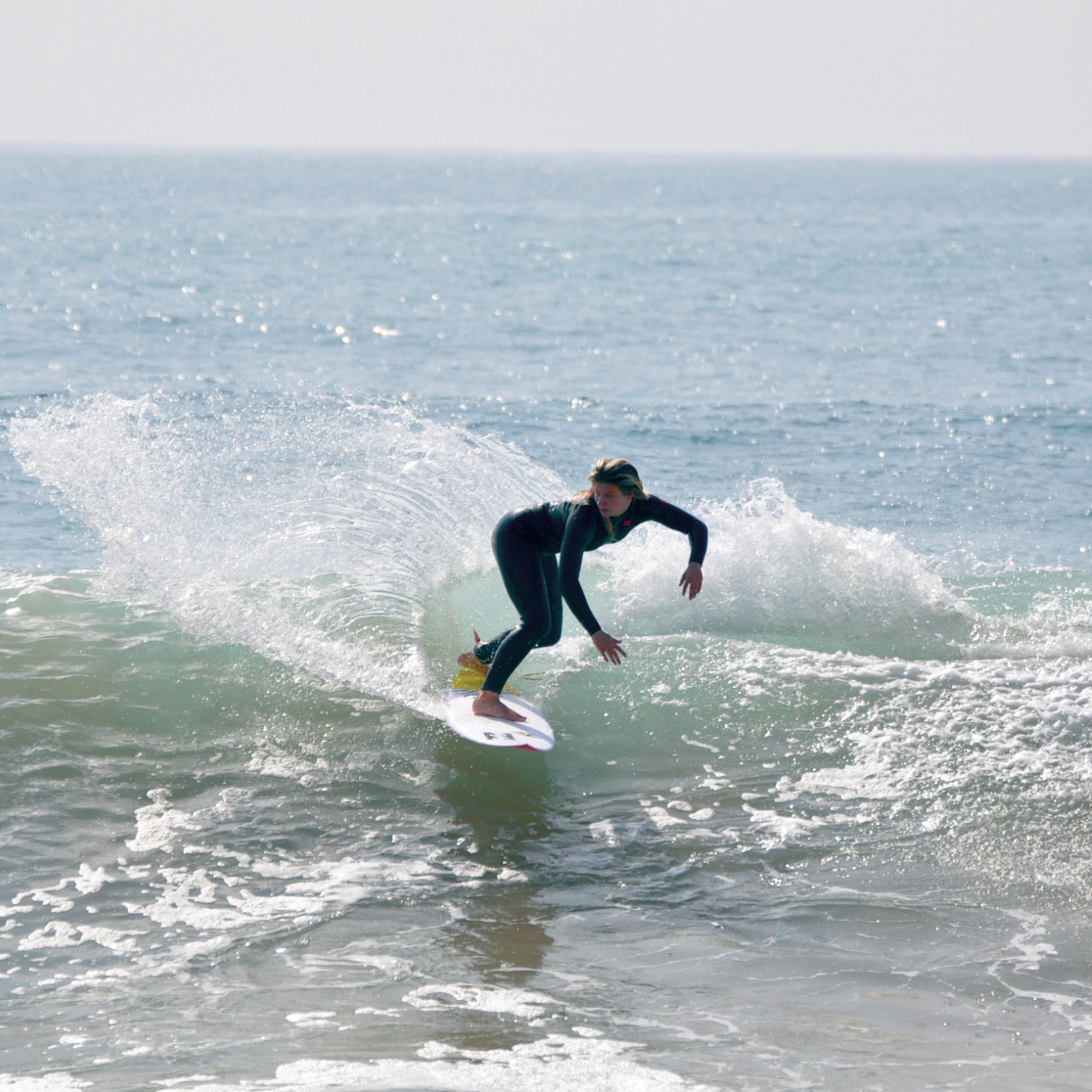 A woman surfing at Mint Surf