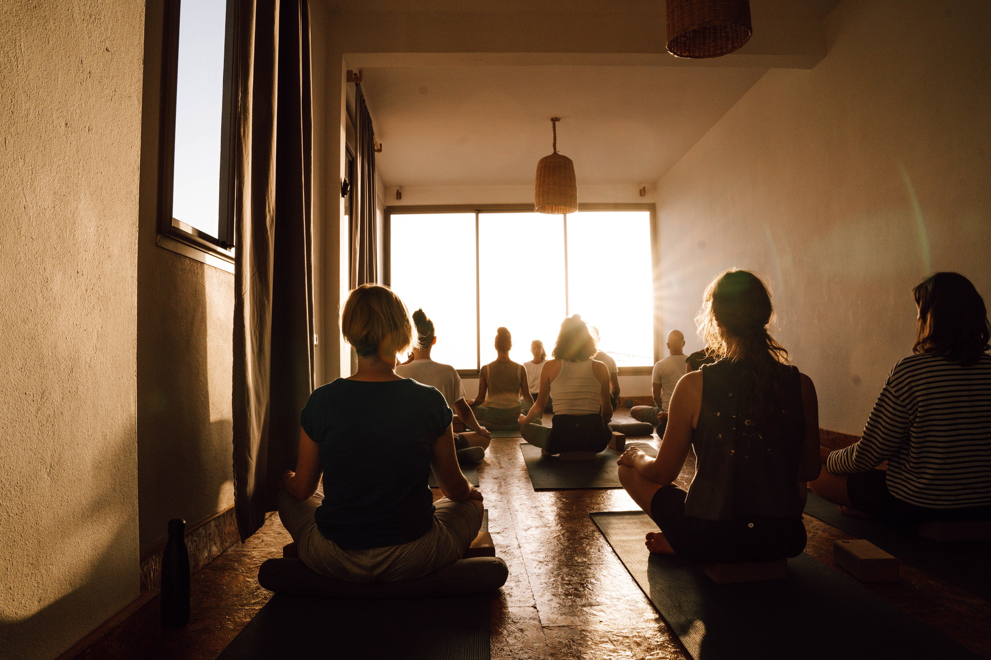 Yoga class sitting in low evening light at Blue Mind Surf and Yoga Tribe