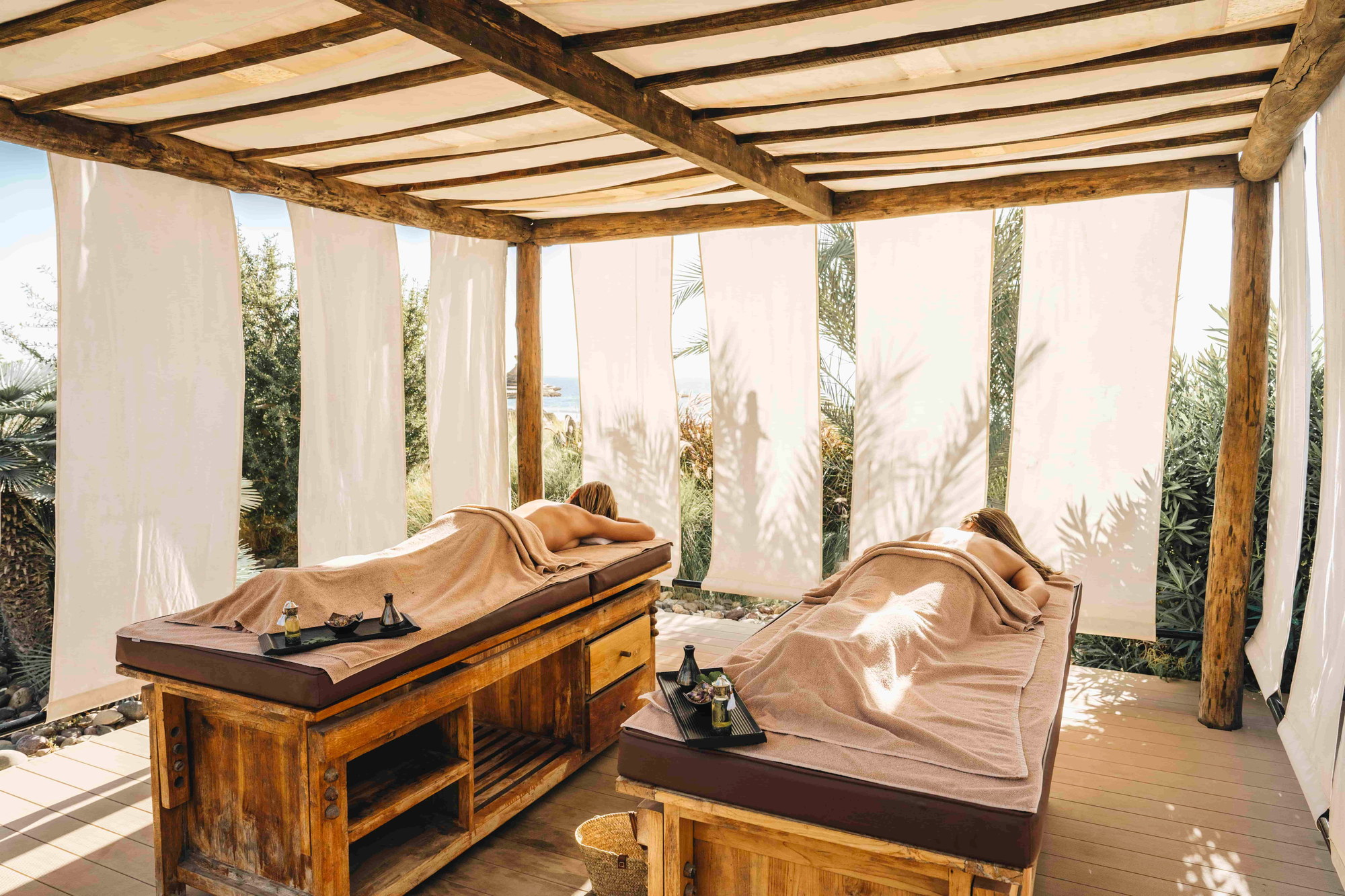 Open-air massage beds under a canvas pergola at the Paradise Eco Spa, Paradis Plage, Morocco