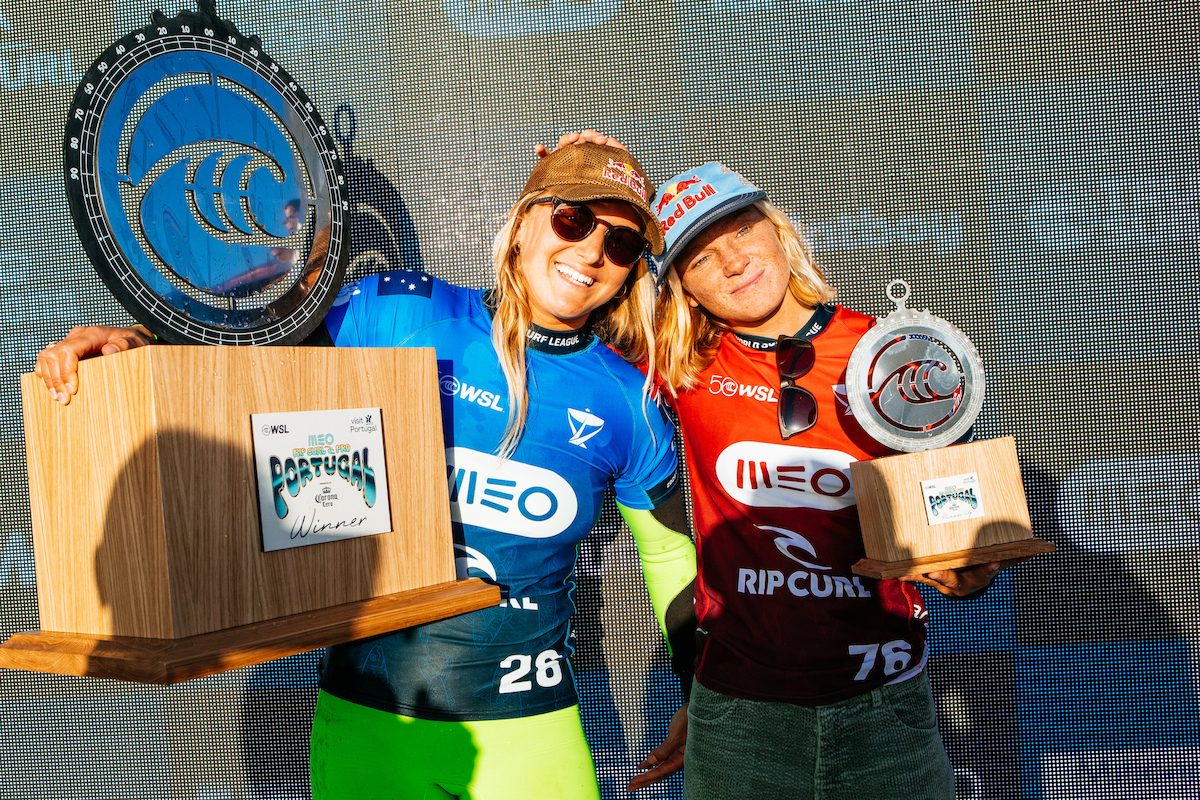 Molly Picklum and Caitlin Simmers smiling together on the podium, Picklum holding the winner's trophy and Simmers the runner-up trophy